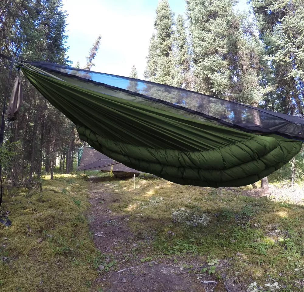 olive green wooki underquilt attached to a hammock