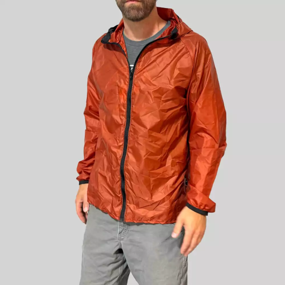 Person wearing autumn orange rain jacket showing front view