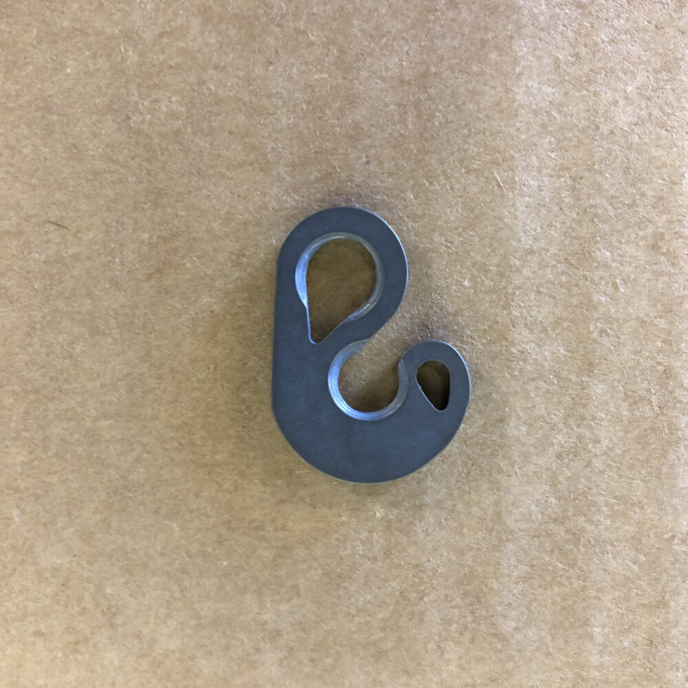 titanium fishhook hardware On a Brown Surface