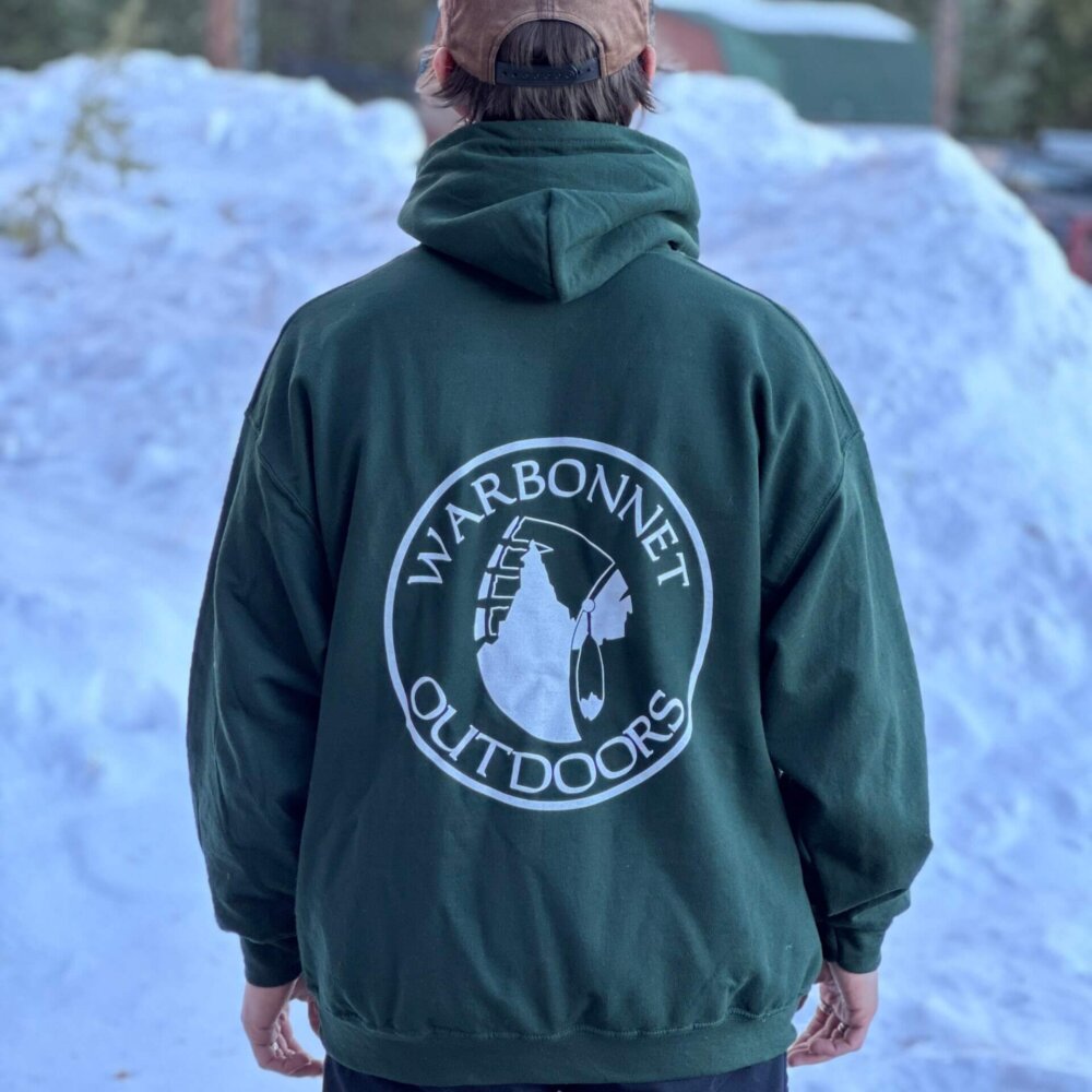 Back view of a person wearing a green Warbonnet logo hoodie