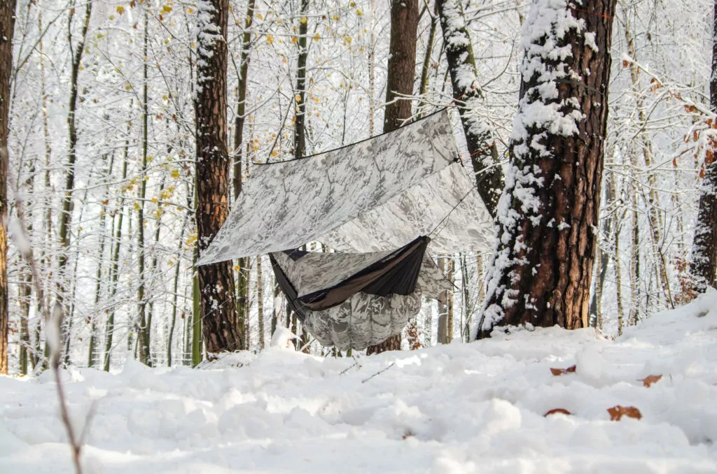 A Snow Day camouflage tarp attached to a Blackbird XLC Hammock with a Snow Day camouflage Wooki underquilt