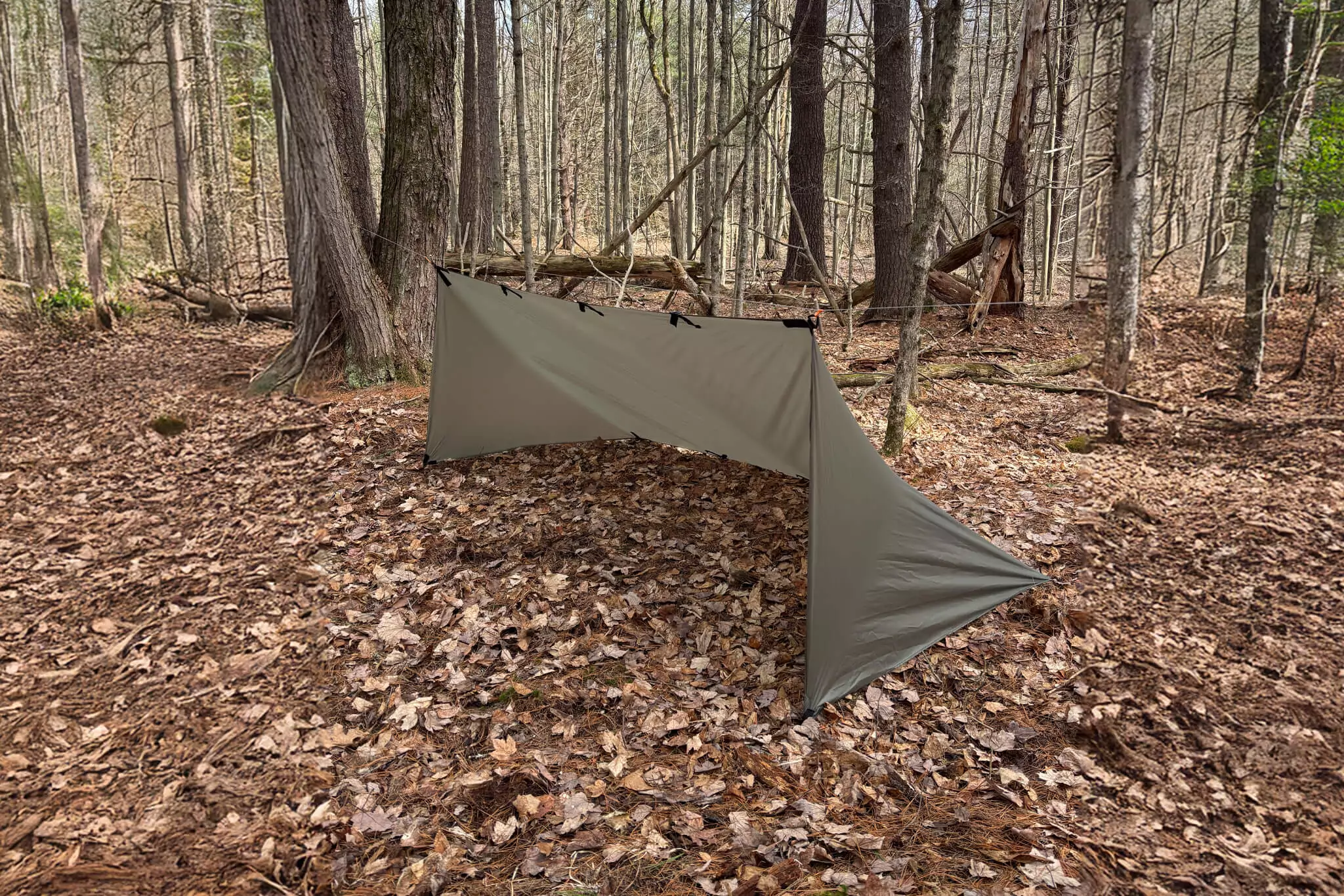 warbonnet bushcrafter tarp set up on ground showing front angle